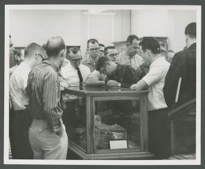 Museum - People viewing artifacts in display case