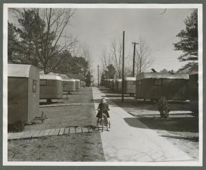 Residence halls - Child riding tricycle in mobile home community