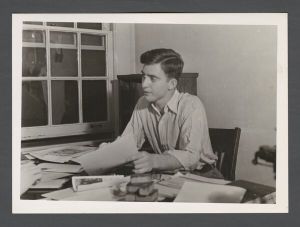 Students, individuals - Unidentified male student sitting at a desk