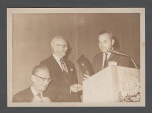Students, groups, 1970s - Unidentified man receives plaque at event