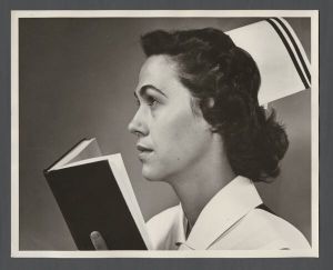 School of Medicine - Portrait photograph of a unidentified nurse holding a book