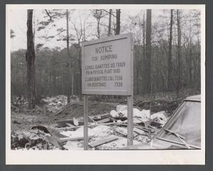 Environmental campus photographs: trash, dumps, etc. - Sign and piles of trash
