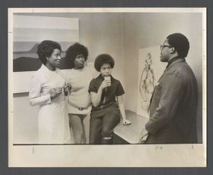 Students, groups, 1970s - Man talking to three women