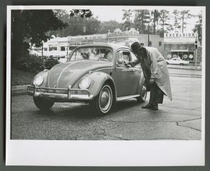 Emory Village - Man talking to people in a car