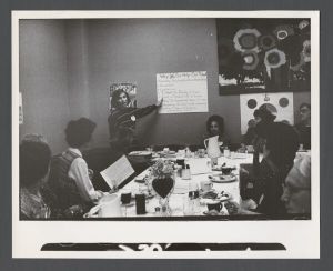 School of Nursing - Woman makes presentation regarding the School of Nursing over a meal