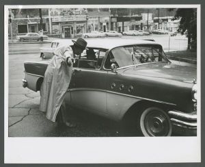 Emory Village - Man talking to people in a car