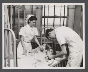 School of Medicine - Doctor and nurse examine child
