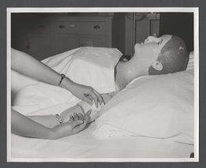 School of Nursing - Student nurses practice giving injections on a mannequin patient