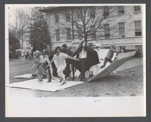 Students, groups, 1970s - Students in costumes breaking out of a box on the quad