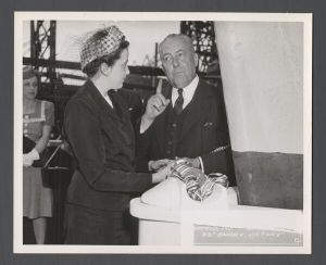 Launch of Emory Victory, 1945 - Mrs. Cox and unidentified figure by the sails