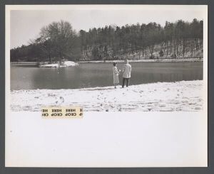 Unusual weather on campus - Two people standing by Lullwater lake in snow