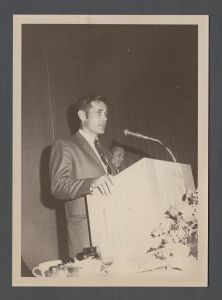 Students, groups, 1970s - Unidentified man speaking from podium