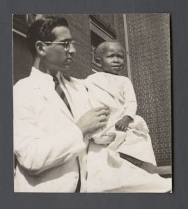 School of Medicine - Doctor holding small child
