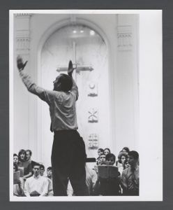 College of Arts and Sciences - Professor of Music William Lemonds leading choir in Glenn Memorial church