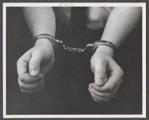 Candid campus photographs with unidentified individuals - Man in handcuffs