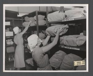 School of Nursing - Student nurses folding sheets and putting them onto shelves