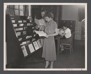 Library Special Collections - Staff reading the "Librarian" magazine