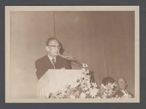 Students, groups, 1970s - Unidentified man speaking from podium