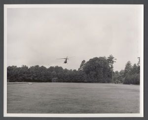 Aerial campus photographs - Helicopter taking off from athletic field