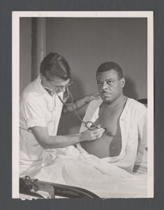School of Medicine - Student using a stethoscope on patient