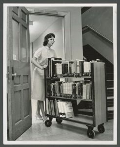 Library - Mrs. Kay Clarke moving a truckload of new books from the Catalog department to the Circulation department