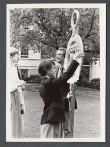 Commencement, 1970s and 1980s - Susan Laney adds note to Omicron Delta Kappa sign