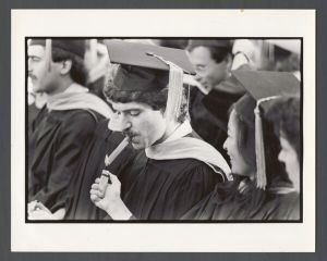 Commencement, 1970s and 1980s - Student lights a cigar