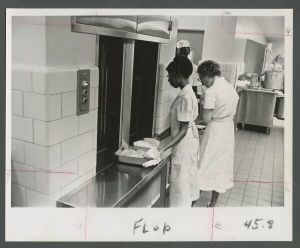 Cox Hall - "Trayveyor" system conveying a pan of cabbage from the kitchen to the cafeteria