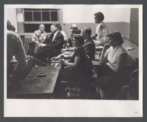 Dances and festivals - Group listens to woman playing guitar