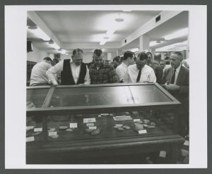Museum - People viewing artifacts in display case