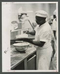 Cox Hall - Kitchen staff icing a cake