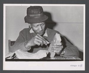 Faculty and staff, unidentified individuals - Custodian whittling a block of wood