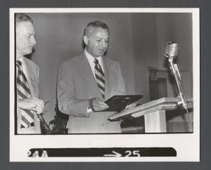 Administrators - Emory President Sanford Atwood looking at plaque in his hand