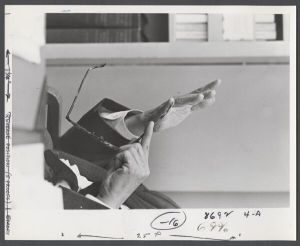 Candid campus photographs with unidentified individuals - Man holding eyeglasses