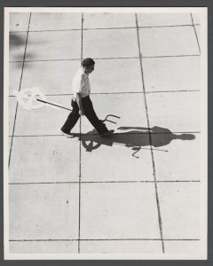 Candid campus photographs with unidentified individuals - Student walking with cross stand
