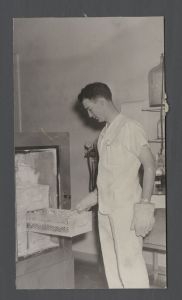 School of Medicine - Man examines materials from a freezer