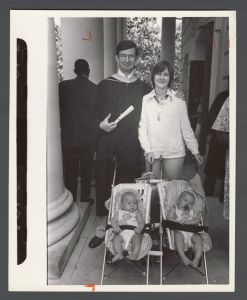 Commencement, 1970s and 1980s - Medical school graduate stands with his wife and two children