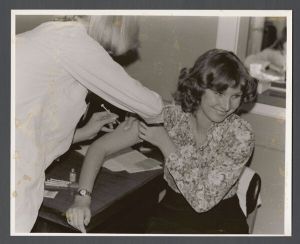 Health and Science Fair - Woman receives a shot