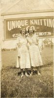 Ladies in front of Unique Knitting Company sign