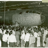 Bell employees gathered around B-29 bomber