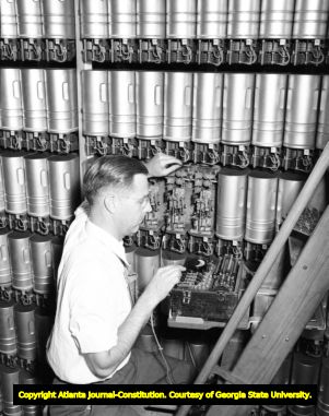 Telephone engineer checking connections on phone lines, circa 1940s