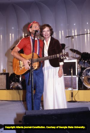 First Lady Rosalynn Carter and Willie Nelson on stage during a White House event, 1978
