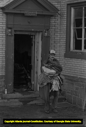 Residents return to salvage their possessions after an apartment fire, 1980