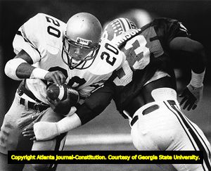 Georgia Tech's Robert Lavette rushes through North Carolina State's Vaughan Johnson, circa 1980s
