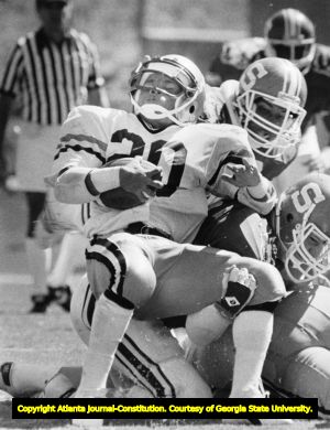 Georgia Tech's Jerry Mays is tackled from behind by the Wolfpack's Mark Franklin and John Adleta, 1985