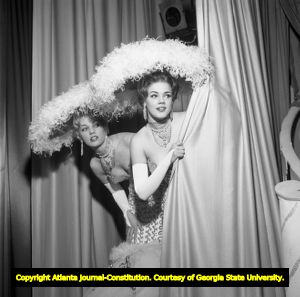 Las Vegas showgirls checking the audience before the show, 1962