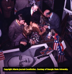 Lester Maddox signing autographs at his souvenir shop in Underground Atlanta, 1972
