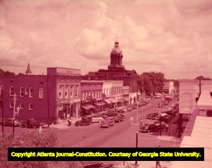 Historic Coweta County Courthouse looming over Newnan's business district, 1950