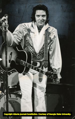 Elvis Presley, holding guitar, performing at the Omni, Atlanta, Georgia, June 4, 1976.