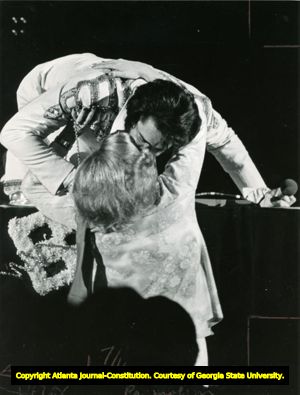 Elvis Presley bends down form stage to kiss a fan, Atlanta, Georgia, April 30, 1975.